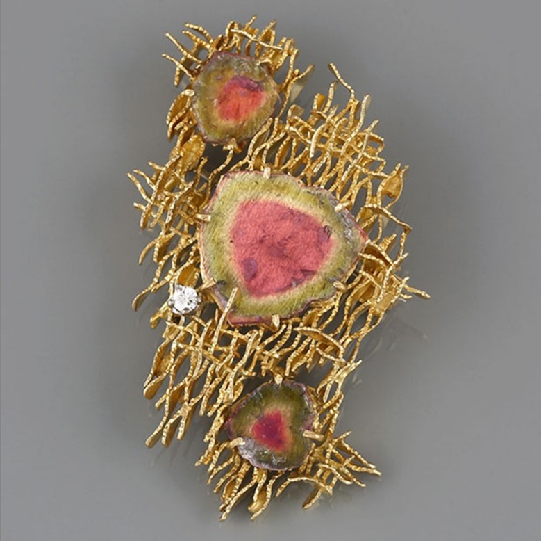 An 18ct gold tourmaline and diamond brooch by Alan Gard, 1967. We would look to insure this piece with a provisional valuation of £10,000, subject to change upon physical inspection of the piece.